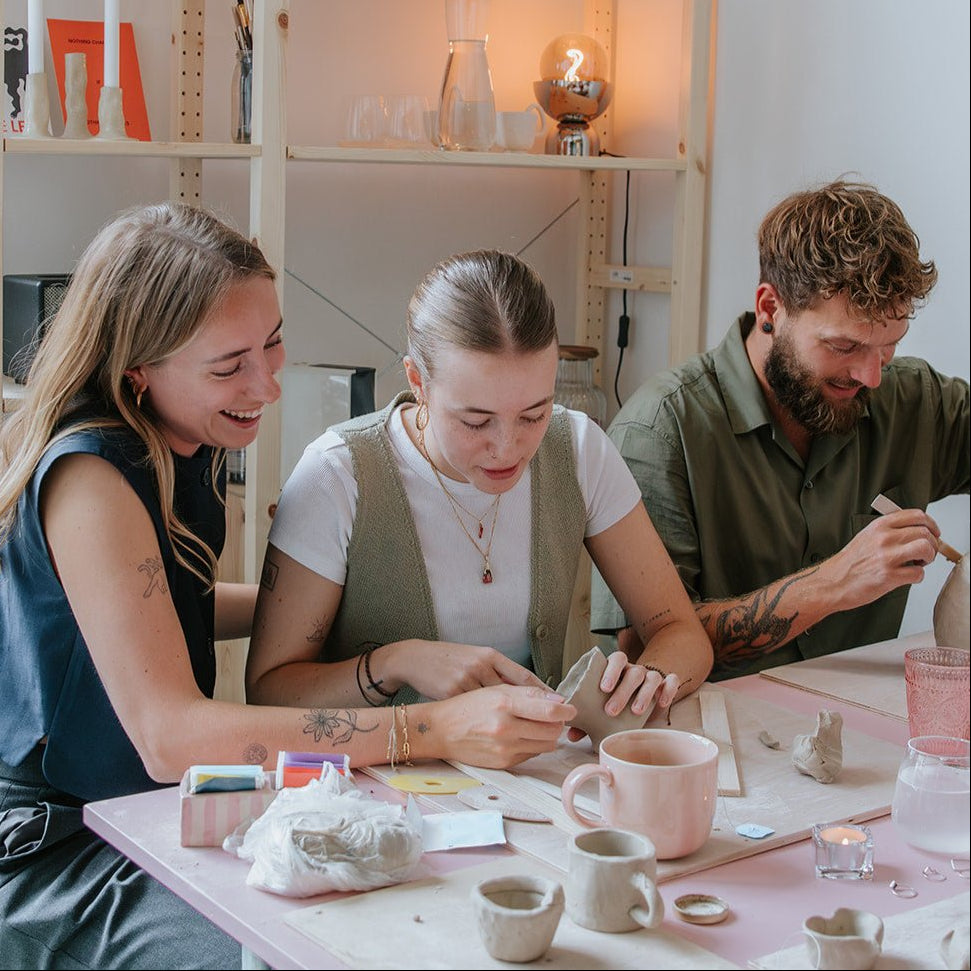 Groep beschildert keramiek tijdens een workshop